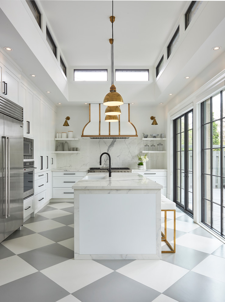 This is an example of a transitional l-shaped kitchen in Toronto with an undermount sink, shaker cabinets, white cabinets, stainless steel appliances and with island.
