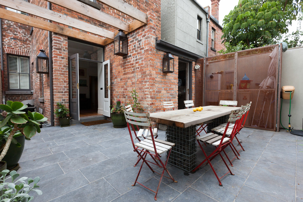 This is an example of a large victorian courtyard patio in Melbourne with a vegetable garden.