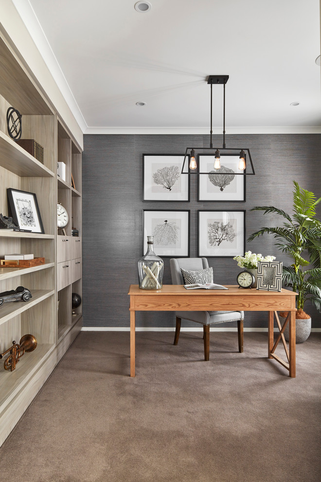 This is an example of a beach style study room in Other with beige walls, carpet, a freestanding desk and beige floor.