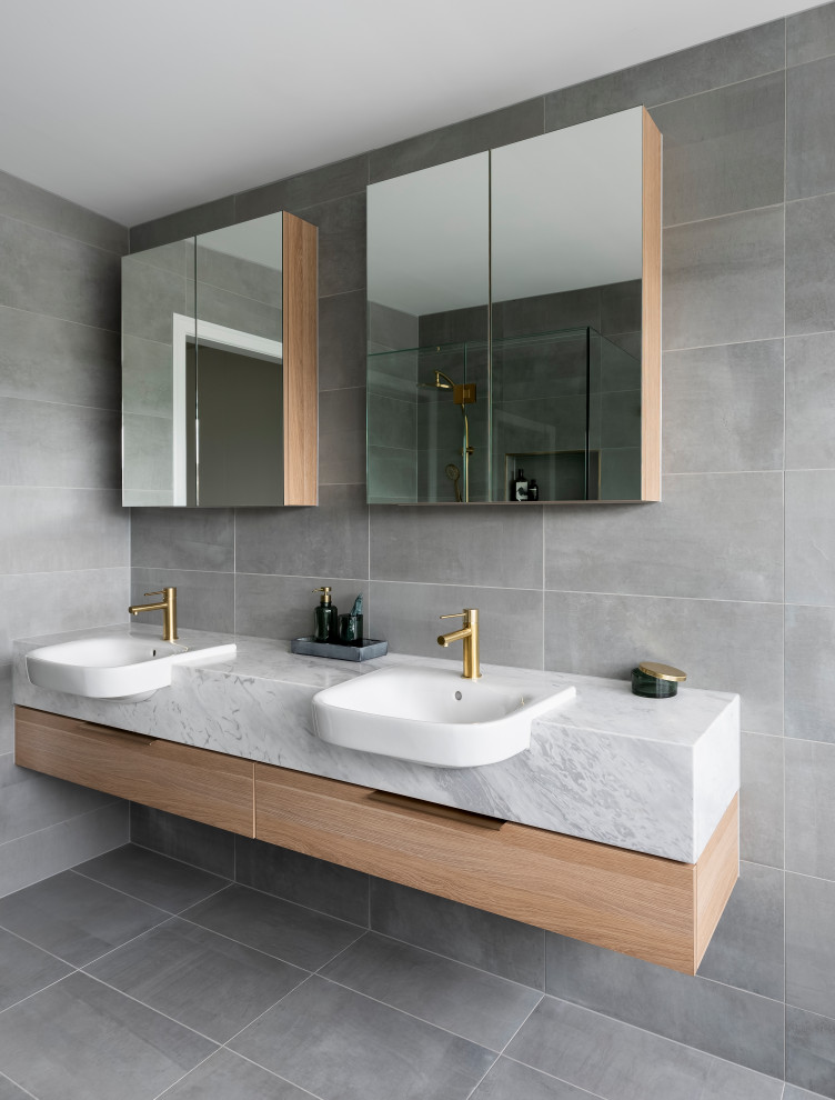 Design ideas for a large contemporary master bathroom in Melbourne with flat-panel cabinets, white cabinets, a freestanding tub, an open shower, a two-piece toilet, gray tile, ceramic tile, white walls, ceramic floors, an integrated sink, grey floor, an open shower, grey benchtops, a niche, a double vanity and a floating vanity.
