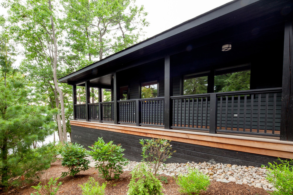 Inspiration for a mid-sized traditional black house exterior in Toronto with wood siding.