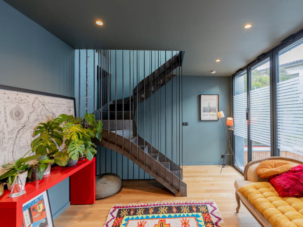 Example of an eclectic metal curved staircase design in Bordeaux with metal risers