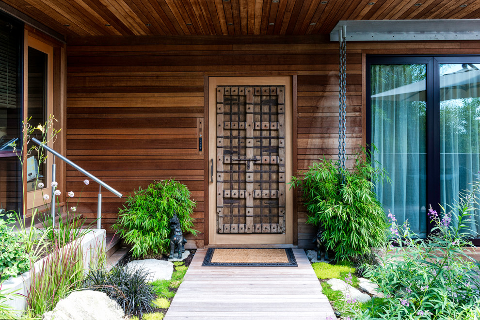 Asian front door in Vancouver with light hardwood floors, a single front door and a light wood front door.