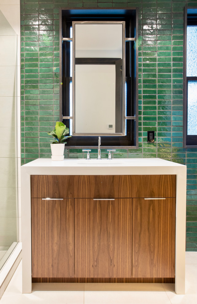 Inspiration for a modern 3/4 bathroom in Seattle with flat-panel cabinets, brown cabinets, a two-piece toilet, green tile, ceramic tile, green walls, porcelain floors, an undermount sink, solid surface benchtops, white floor, a sliding shower screen, white benchtops, a single vanity and a freestanding vanity.