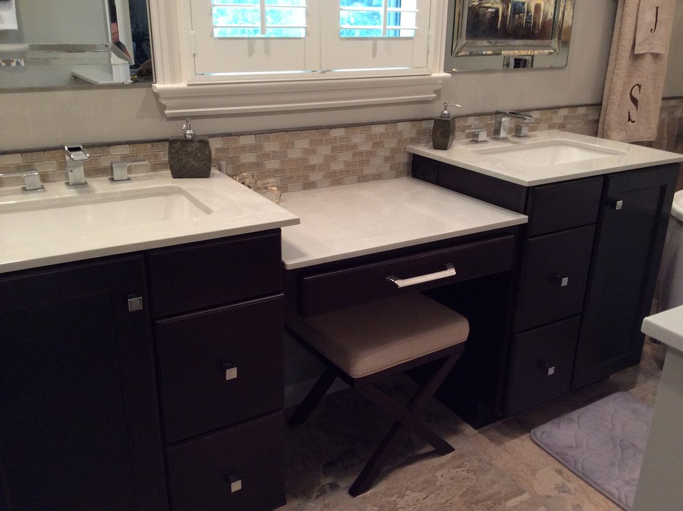 Example of a mid-sized transitional master beige tile and ceramic tile ceramic tile freestanding bathtub design in Birmingham with an undermount sink, flat-panel cabinets, dark wood cabinets, marble countertops, a two-piece toilet and beige walls