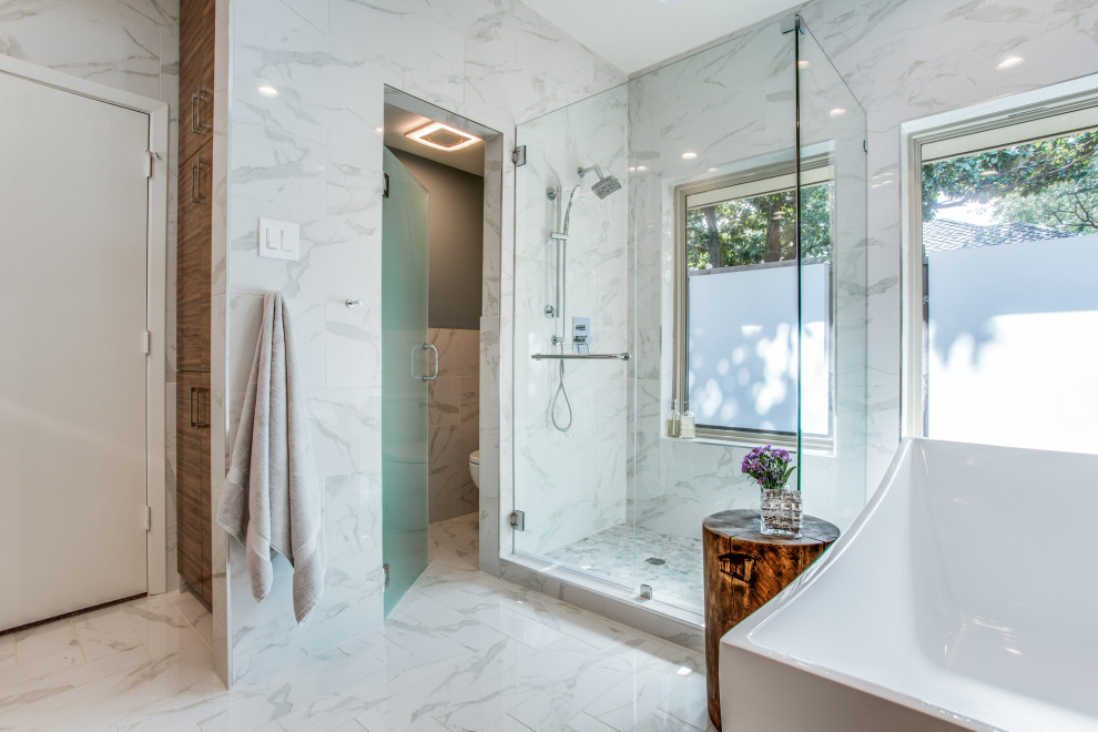 Inspiration for a mid-sized contemporary master bathroom in Dallas with a freestanding tub, an open shower, multi-coloured tile, porcelain tile, multi-coloured walls, multi-coloured floor, a hinged shower door and an enclosed toilet.