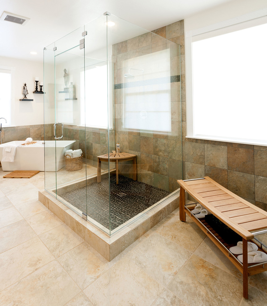 Large eclectic master bathroom in Los Angeles with a freestanding tub, an open shower, multi-coloured tile, beige walls and pebble tile floors.
