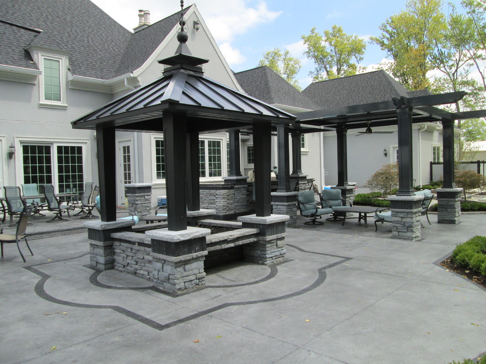 Photo of a large transitional backyard patio in Other with a water feature and natural stone pavers.