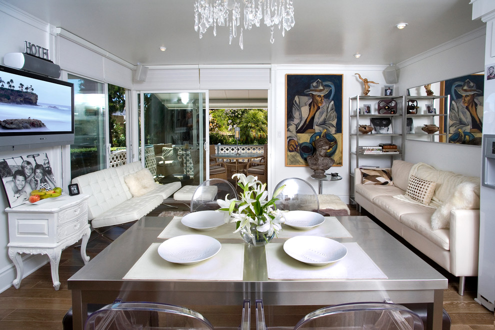 Inspiration for a beach style dining room in Orange County with white walls and dark hardwood floors.