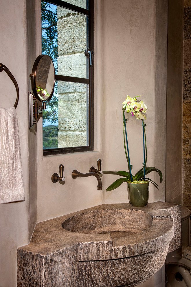 Tuscan powder room photo in Orange County with beige walls and an integrated sink