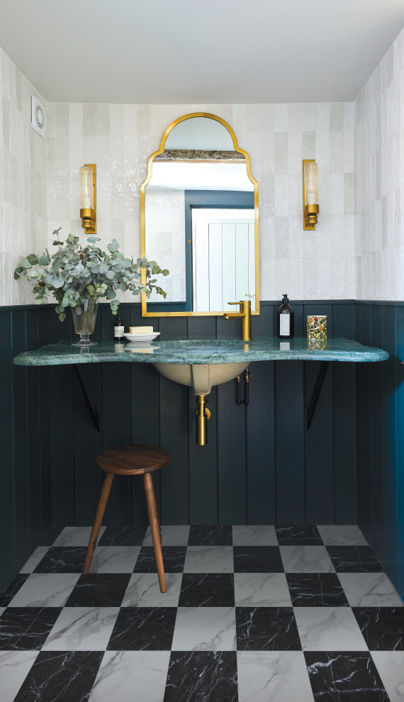 Inspiration for a mid-sized traditional powder room in Belfast with ceramic tile, porcelain floors and tile benchtops.