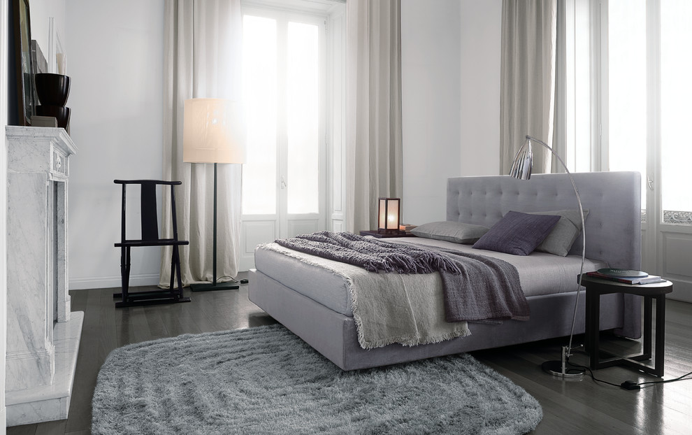 This is an example of a large contemporary master bedroom in Sydney with white walls.