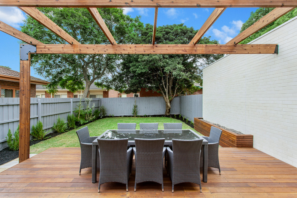 Design ideas for a contemporary backyard deck in Melbourne with a container garden and a pergola.
