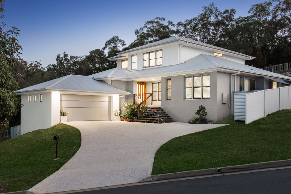 Inspiration for a contemporary two-storey white exterior in Gold Coast - Tweed with a hip roof and a metal roof.