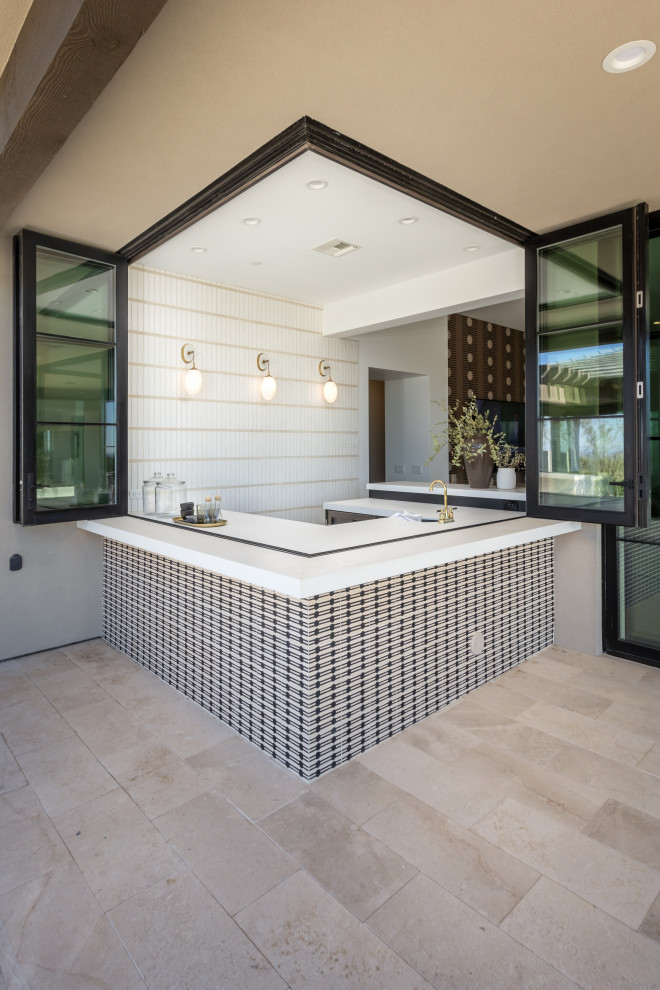 Inspiration for a large transitional u-shaped light wood floor and beige floor wet bar remodel in Phoenix with an integrated sink, raised-panel cabinets, black cabinets, quartz countertops, white backsplash, brick backsplash and white countertops