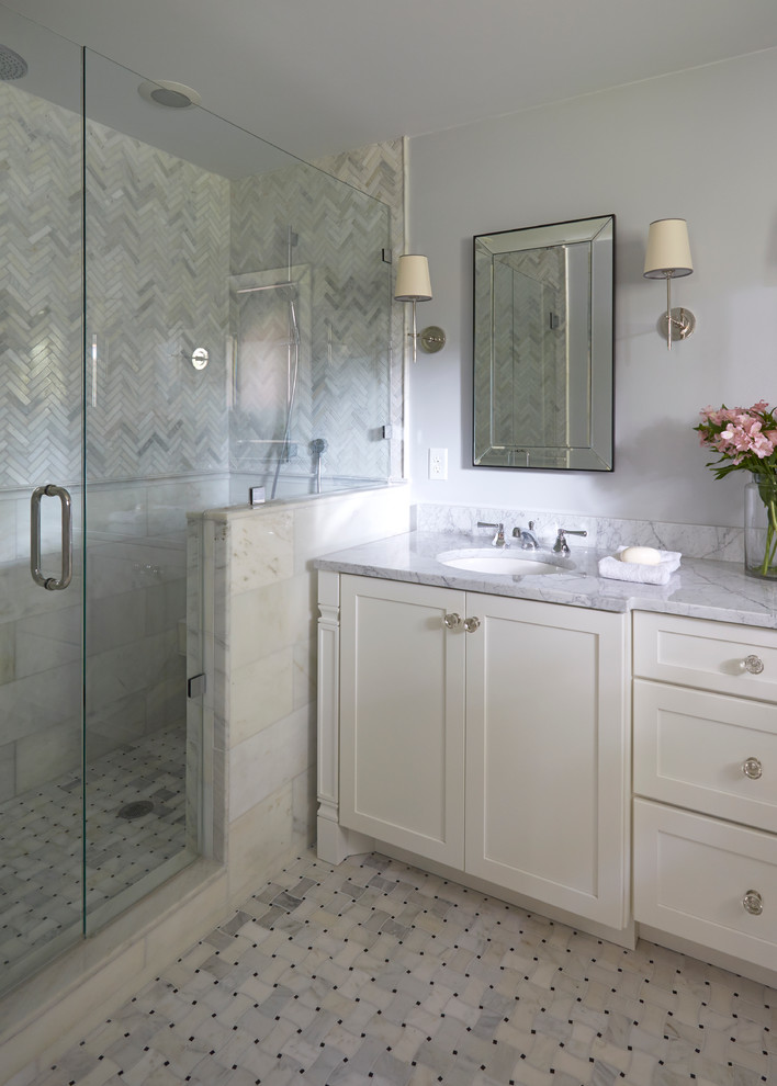 Photo of a mid-sized transitional master bathroom in Jacksonville with shaker cabinets, white cabinets, an open shower, a one-piece toilet, gray tile, mosaic tile, grey walls, marble floors, marble benchtops and an undermount sink.