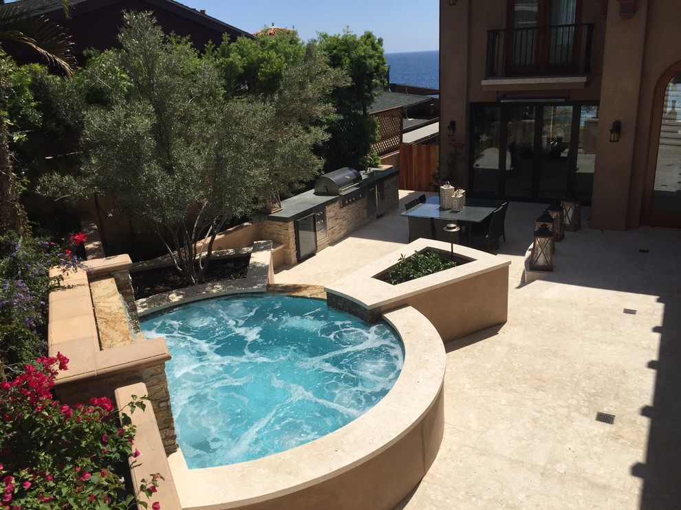 Inspiration for a small contemporary backyard custom-shaped aboveground pool in Orange County with a water feature and concrete slab.