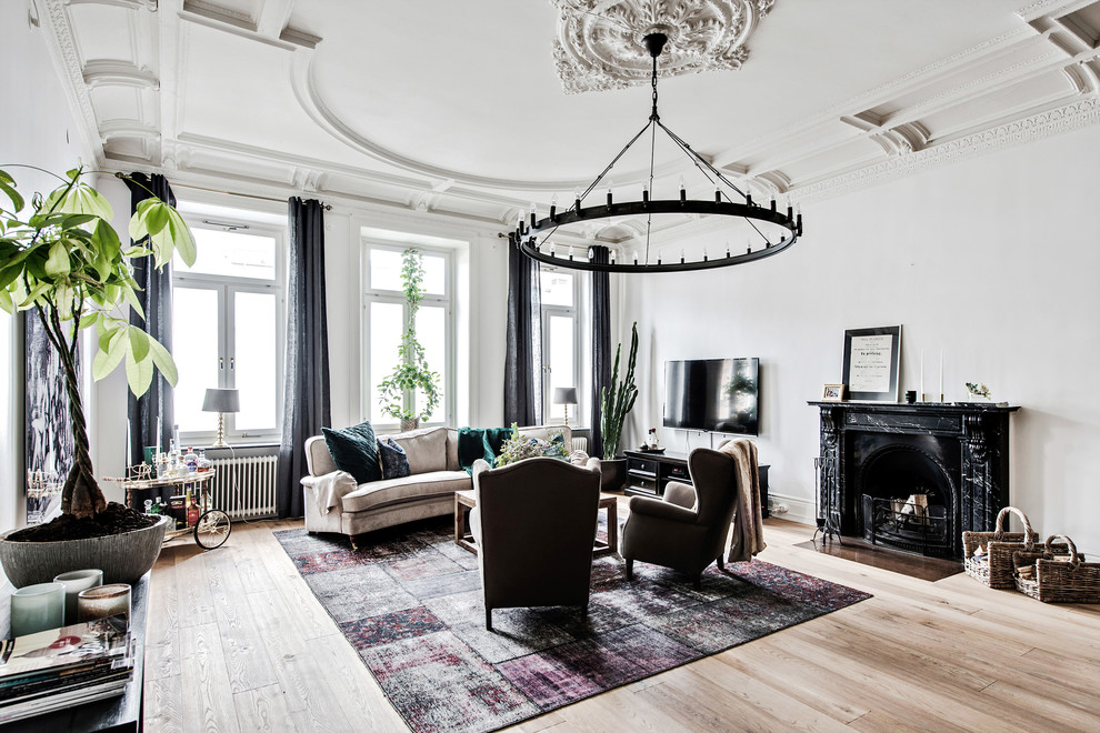 Design ideas for a large traditional living room in Gothenburg with white walls, light hardwood floors, a standard fireplace, a stone fireplace surround, a wall-mounted tv and beige floor.
