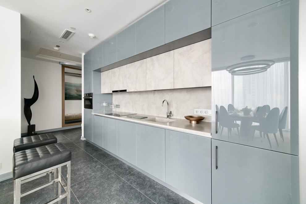 Inspiration for a large contemporary single-wall kitchen in Moscow with an integrated sink, flat-panel cabinets, grey cabinets, white splashback, panelled appliances, no island, grey floor and white benchtop.
