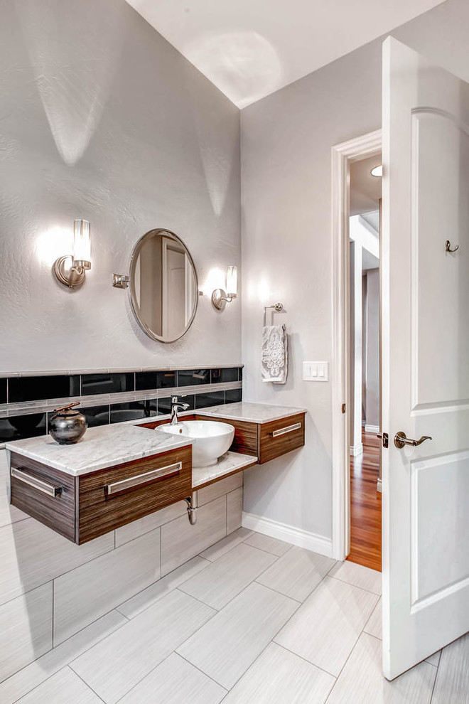 Inspiration for a mid-sized modern 3/4 bathroom in Denver with a vessel sink, flat-panel cabinets, medium wood cabinets, marble benchtops, an open shower, a one-piece toilet, blue tile, glass tile, blue walls and ceramic floors.