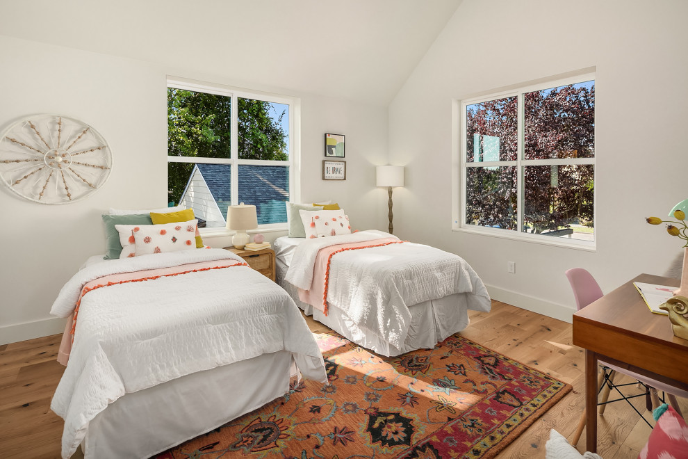 Mid-sized country kids' bedroom in Seattle with white walls, medium hardwood floors and brown floor for kids 4-10 years old and girls.