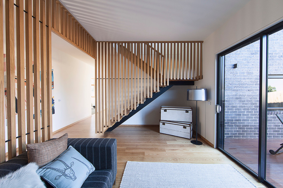 Inspiration for a contemporary wood u-shaped staircase in Melbourne with open risers.