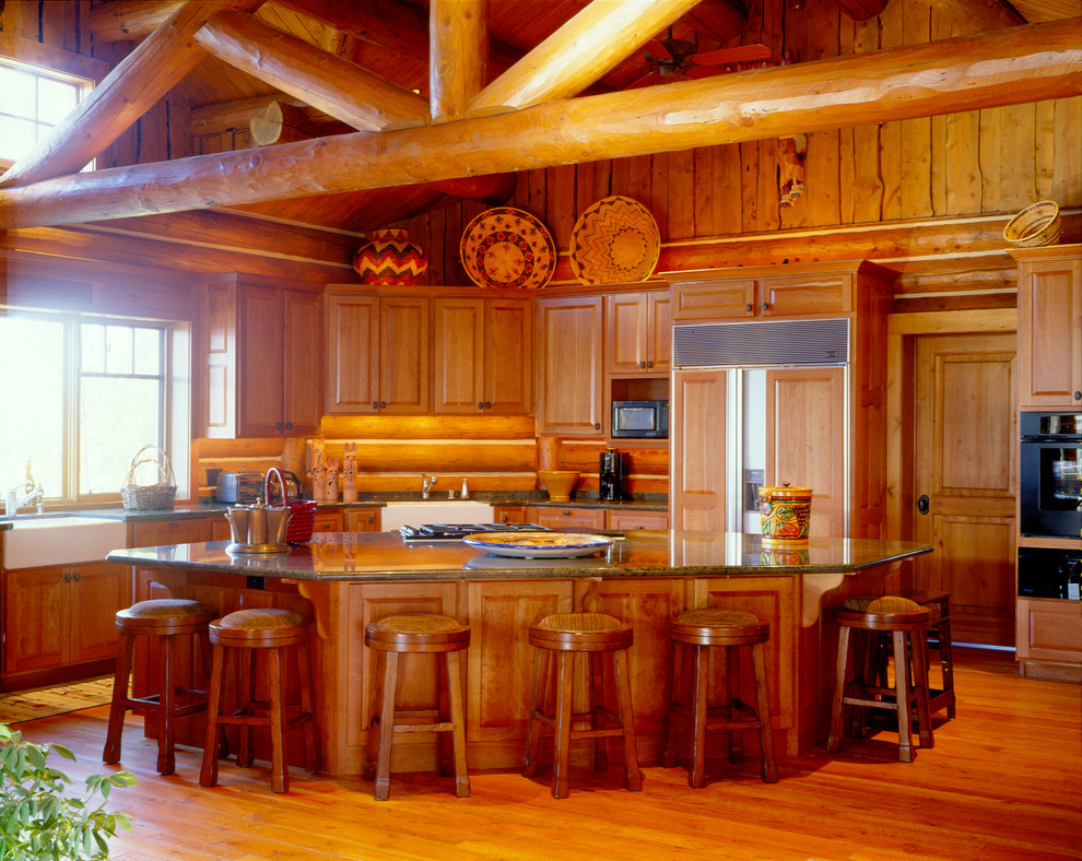 Inspiration for a small country l-shaped kitchen in Other with raised-panel cabinets, medium wood cabinets, granite benchtops, panelled appliances, medium hardwood floors and with island.