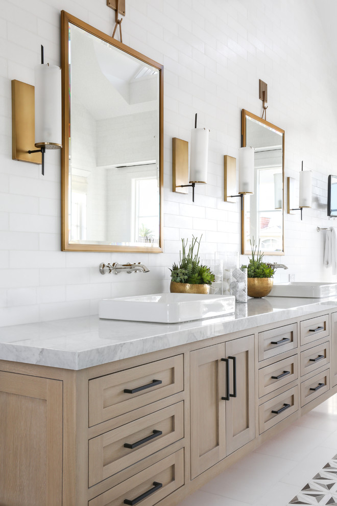 Large modern master bathroom in Orange County with shaker cabinets, light wood cabinets, white tile, subway tile, white walls, a vessel sink, marble benchtops and white floor.