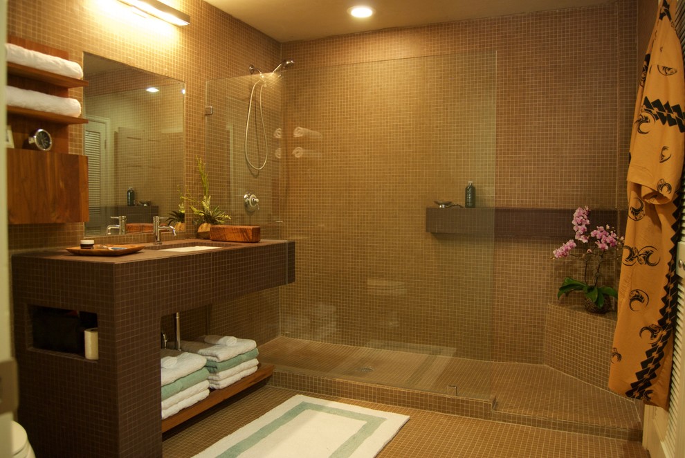 Photo of a small modern 3/4 bathroom in Houston with an open shower, brown tile, ceramic floors, an undermount sink, tile benchtops, open cabinets, brown cabinets, a one-piece toilet, ceramic tile, brown walls, brown benchtops, brown floor and an open shower.
