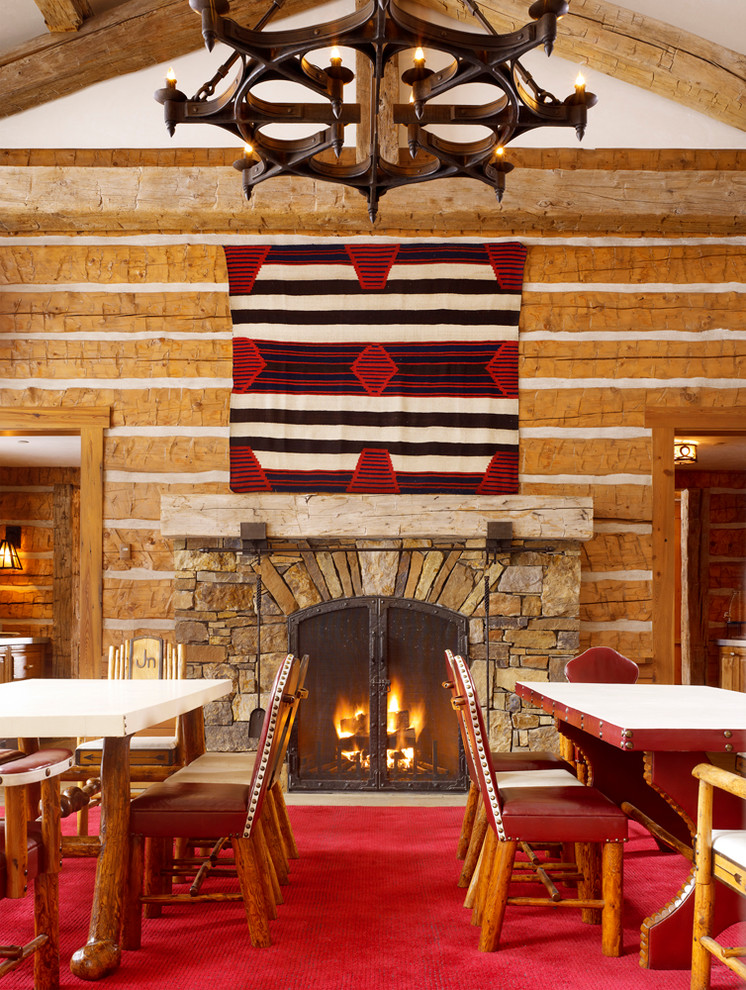 This is an example of a country dining room in Salt Lake City with a standard fireplace and a stone fireplace surround.