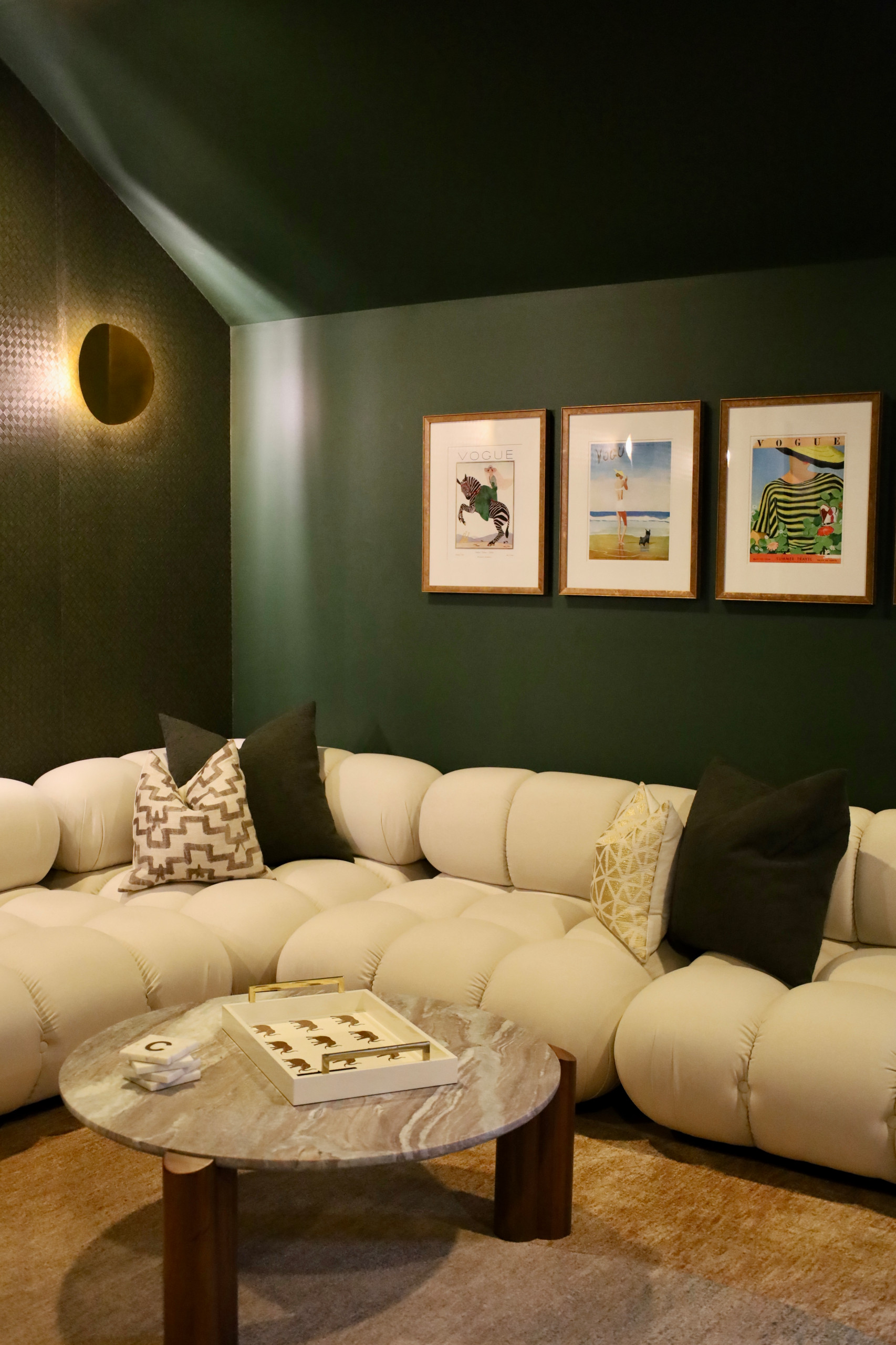 This custom-designed home movie room with built-in bar blends luxury, comfort, and functionality to create the ultimate entertainment space. Rich deep green walls and blackout drapes set a dramatic to