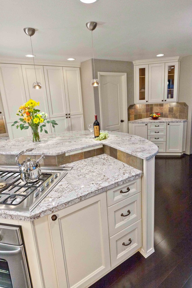 Example of a large transitional galley dark wood floor eat-in kitchen design in Seattle with an undermount sink, white cabinets, granite countertops, stainless steel appliances and an island