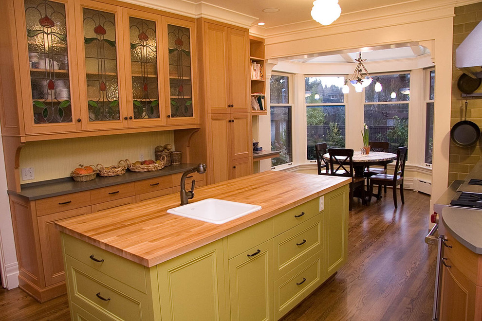 Inspiration for a contemporary eat-in kitchen in Seattle with recessed-panel cabinets, wood benchtops, a drop-in sink and green cabinets.