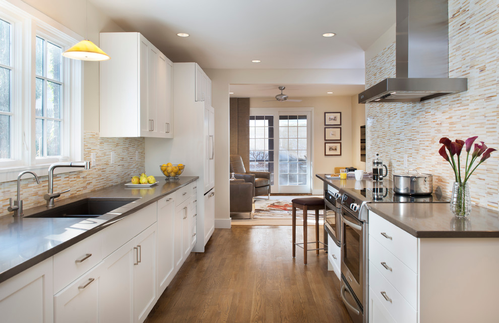Contemporary separate kitchen in Boston with panelled appliances and quartz benchtops.