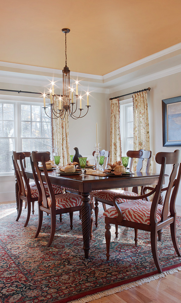 Design ideas for a mid-sized traditional separate dining room in Boston with beige walls and light hardwood floors.