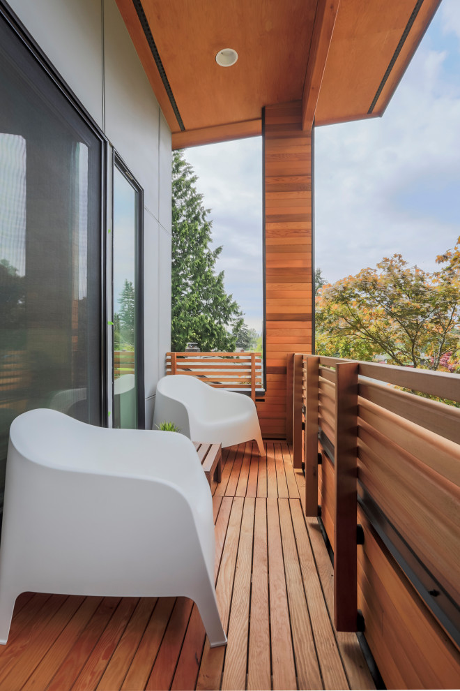 Design ideas for a rooftop deck in Seattle with a roof extension and wood railing.
