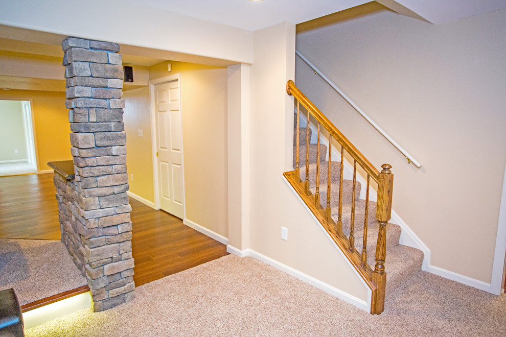 Photo of a large contemporary look-out basement in DC Metro with beige walls, vinyl floors and a ribbon fireplace.