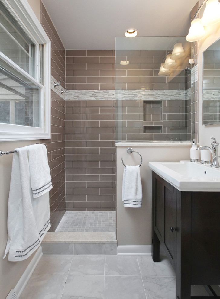 Design ideas for a mid-sized modern master bathroom in Philadelphia with shaker cabinets, dark wood cabinets, an open shower, a two-piece toilet, beige tile, beige walls, porcelain floors and an integrated sink.