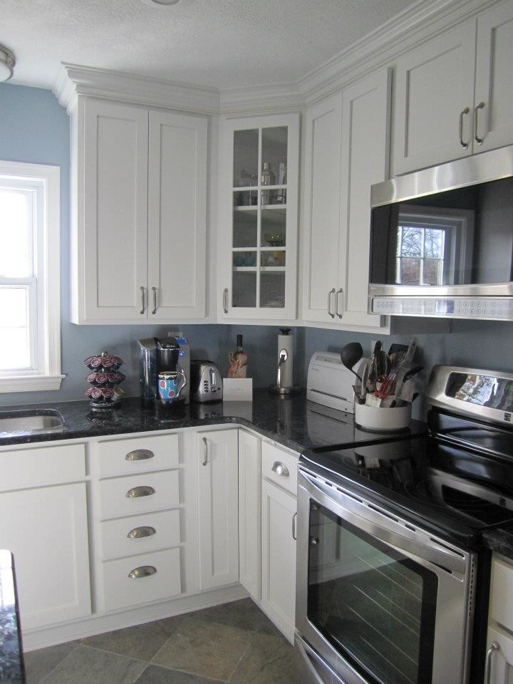 Transitional kitchen photo in DC Metro with an undermount sink, shaker cabinets, white cabinets, granite countertops, stainless steel appliances and an island