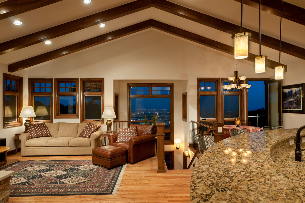 Inspiration for a traditional open concept living room in Seattle with white walls and light hardwood floors.