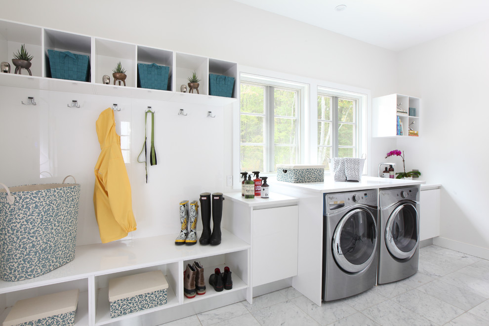 Photo of a large contemporary l-shaped utility room in Other with an undermount sink, flat-panel cabinets, white cabinets, quartz benchtops, white walls, marble floors, a side-by-side washer and dryer and white floor.