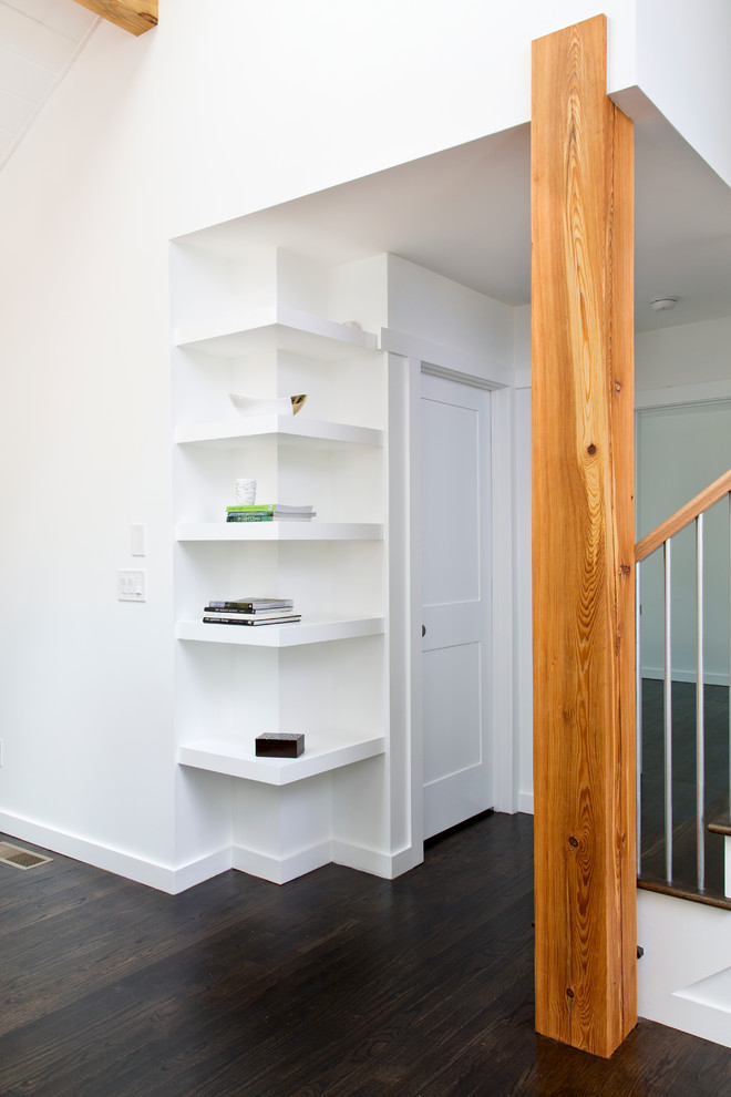 Design ideas for a small transitional hallway in Atlanta with white walls and dark hardwood floors.