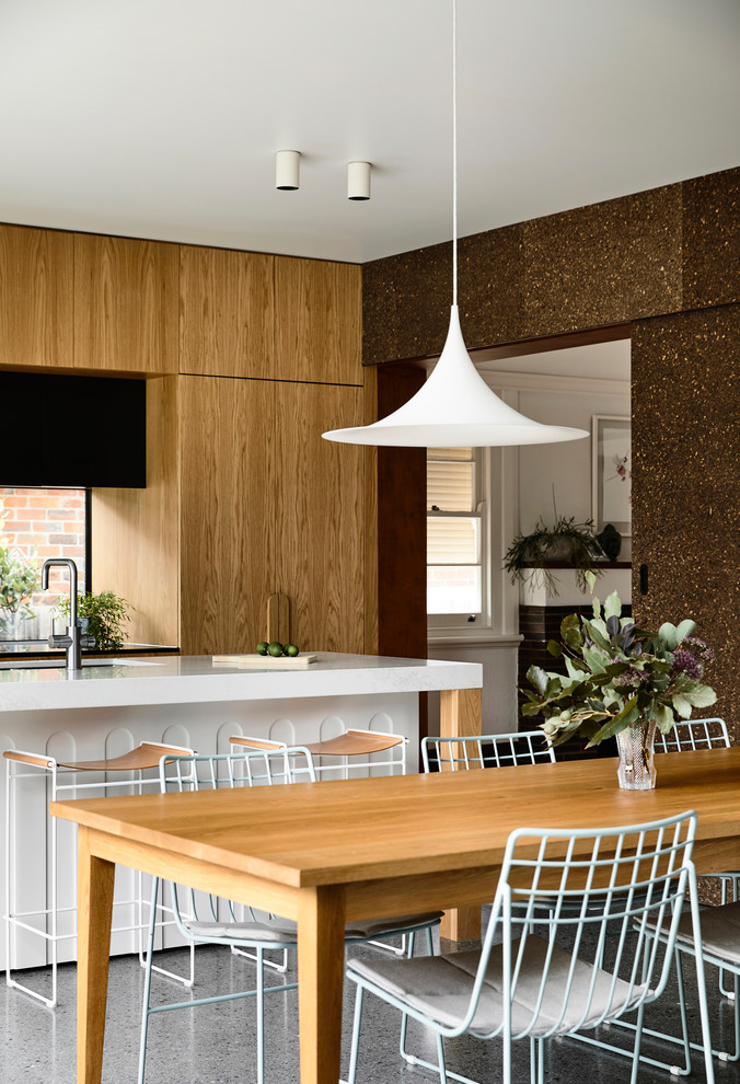 Mid-sized contemporary kitchen/dining combo in Melbourne with concrete floors, grey floor and brown walls.