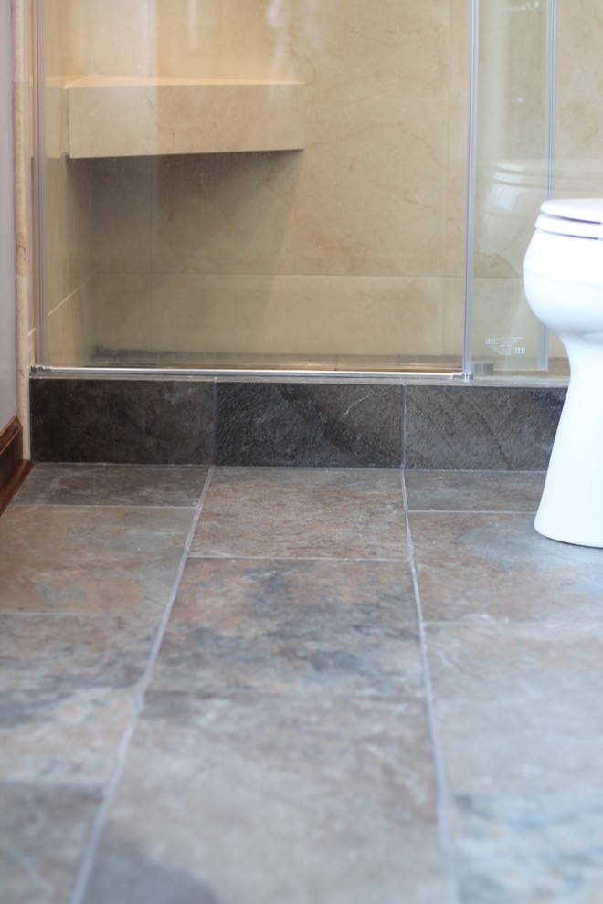 Example of a mid-sized transitional master gray tile and porcelain tile porcelain tile alcove shower design with shaker cabinets, dark wood cabinets, a two-piece toilet, gray walls, an undermount sink and granite countertops
