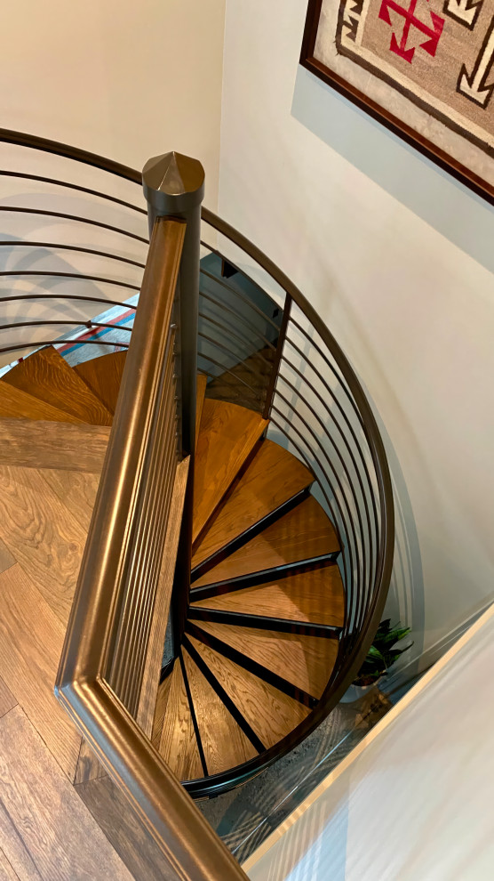 Design ideas for an industrial wood spiral staircase in Minneapolis with metal railing.