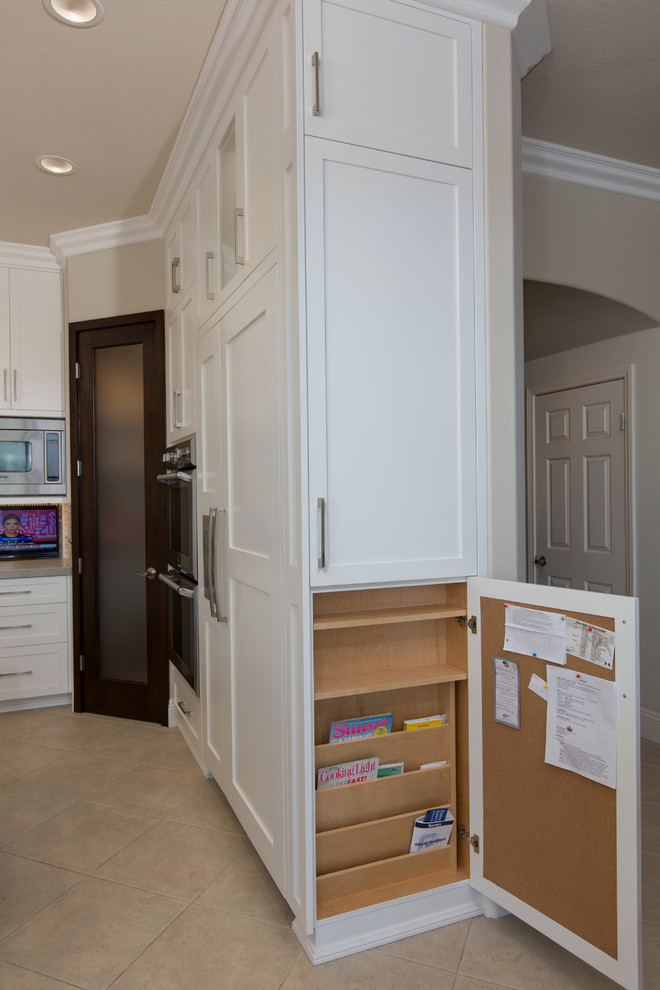 Photo of a mid-sized transitional u-shaped kitchen pantry in San Diego with an undermount sink, recessed-panel cabinets, white cabinets, quartzite benchtops, grey splashback, cement tile splashback, stainless steel appliances, porcelain floors and with island.