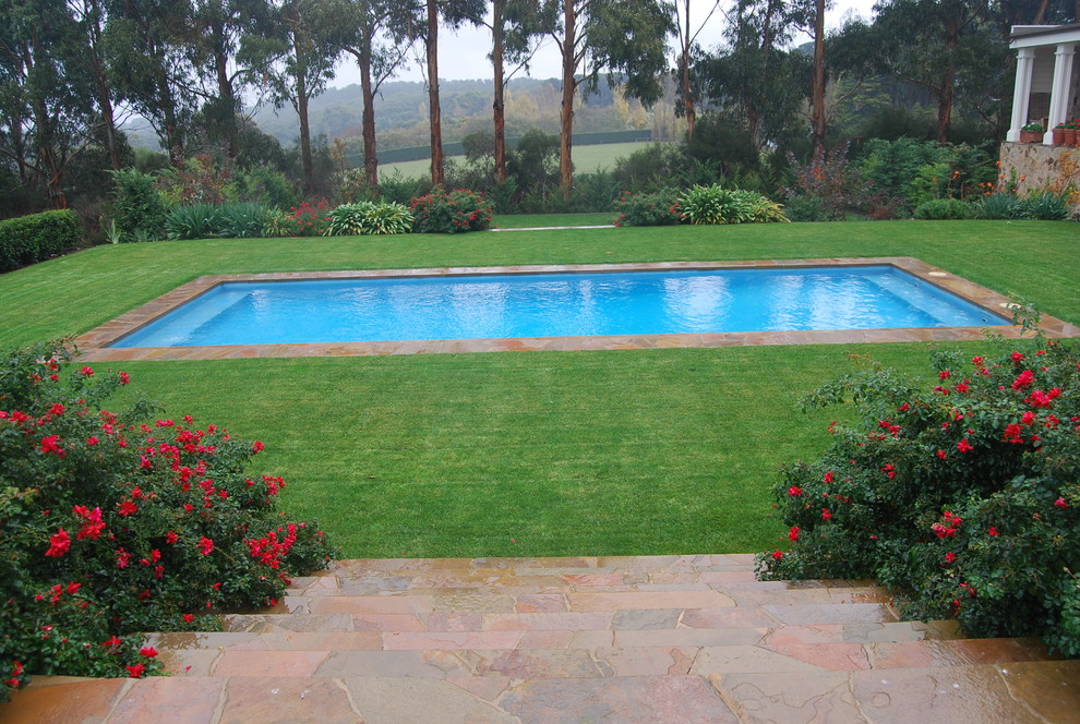 Photo of a mid-sized traditional backyard rectangular pool in Melbourne.