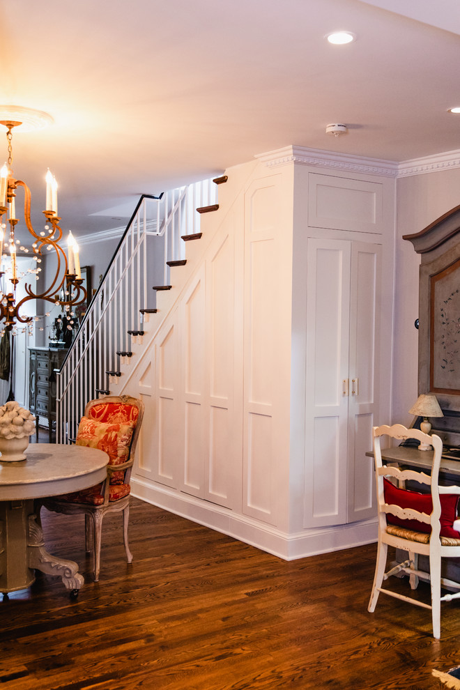 Inspiration for a mid-sized traditional wood straight staircase in DC Metro with painted wood risers and wood railing.