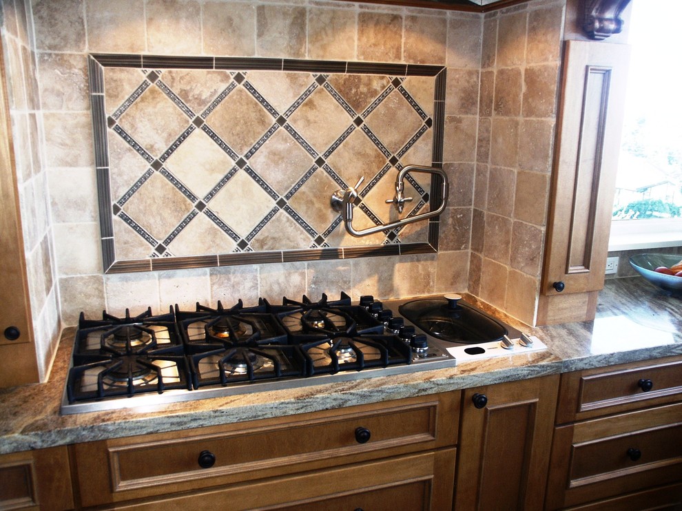 Transitional kitchen photo in Seattle with raised-panel cabinets, granite countertops, beige backsplash and stone tile backsplash