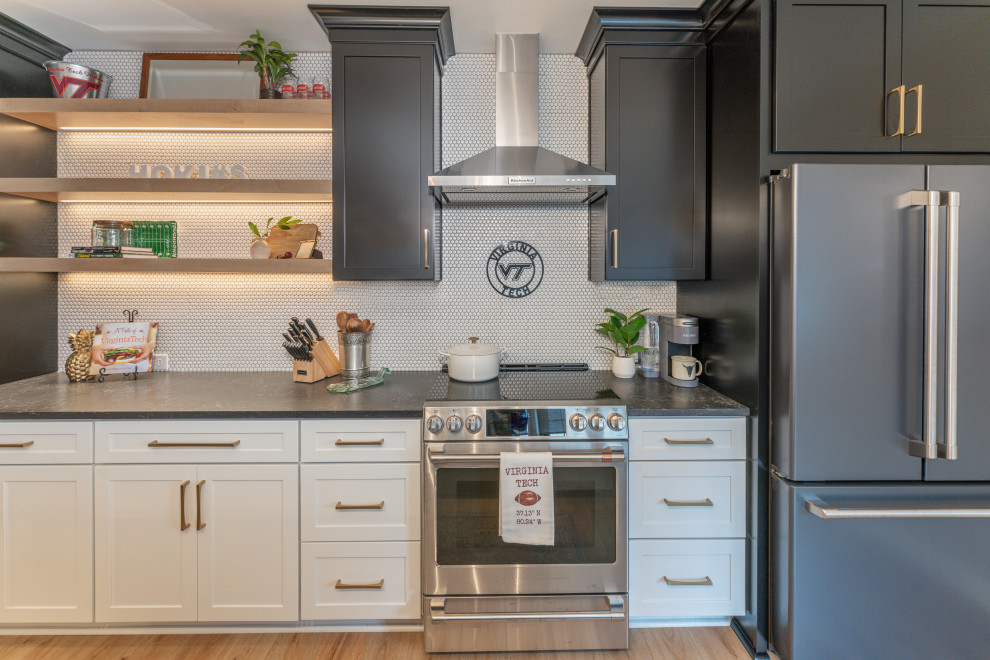 This is an example of a mid-sized country galley eat-in kitchen in DC Metro with an undermount sink, recessed-panel cabinets, quartz benchtops, white splashback, stainless steel appliances and with island.
